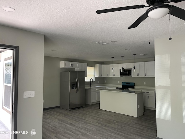 1517 W 33rd Rd, St, Jacksonville, FL 32209 - kitchen featuring dark wood-style floors, appliances with stainless steel finishes, a ceiling fan, and a sink