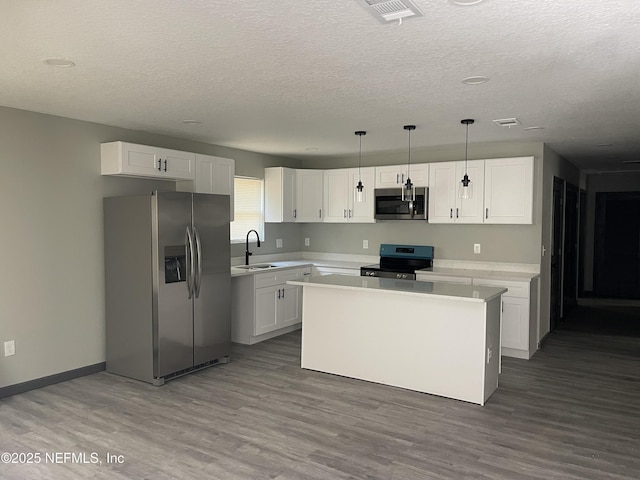 1517 W 33rd Rd, St, Jacksonville, FL 32209 - kitchen featuring white cabinets, stainless steel appliances, light countertops, and a sink
