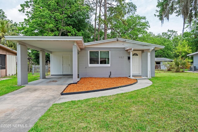 single story home with fence, a front lawn, concrete driveway, and an attached carport