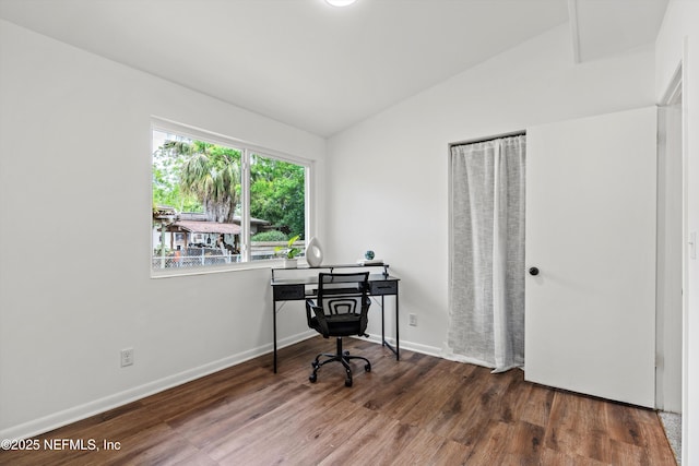 home office featuring lofted ceiling, wood finished floors, and baseboards