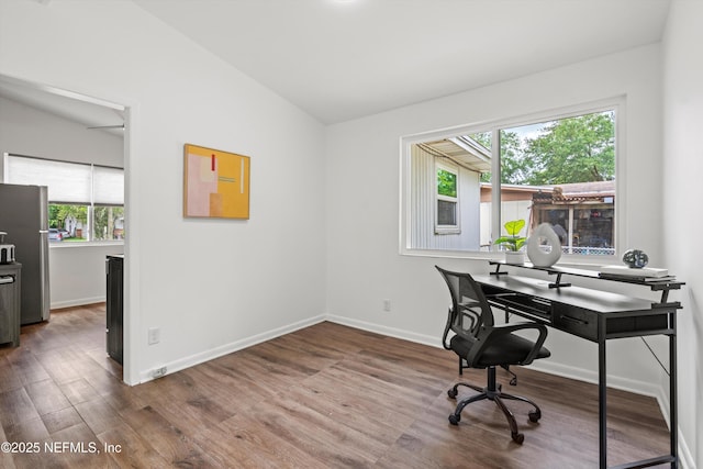 office space featuring wood finished floors, vaulted ceiling, and baseboards