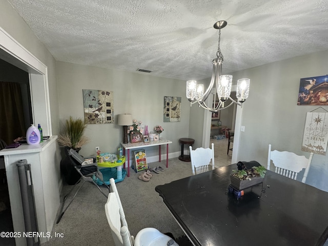 carpeted dining room featuring baseboards, a notable chandelier, a textured ceiling, and visible vents