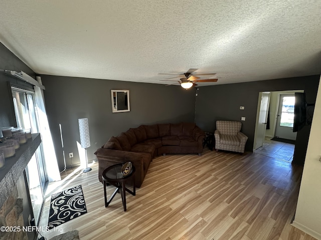 11726 Tanager Dr, Jacksonville, FL 32225 - living area with light wood-type flooring, a textured ceiling, and ceiling fan