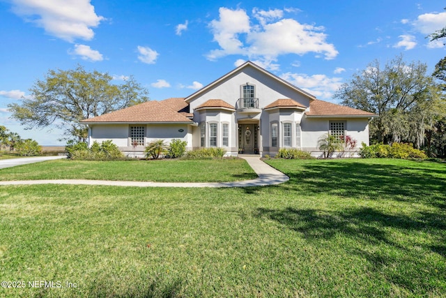 5698 Grand Cayman Rd, Jacksonville, FL 32226 - mediterranean / spanish-style house featuring stucco siding and a front yard