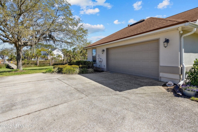5698 Grand Cayman Rd, Jacksonville, FL 32226 - exterior space featuring stucco siding, concrete driveway, and a garage