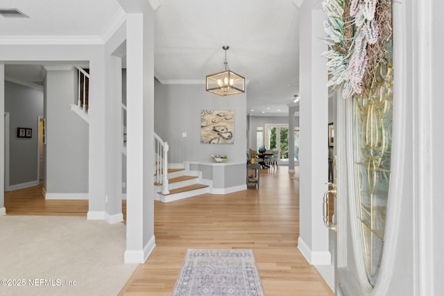 5698 Grand Cayman Rd, Jacksonville, FL 32226 - entryway featuring visible vents, light wood-style flooring, ornamental molding, and stairway