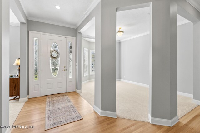 5698 Grand Cayman Rd, Jacksonville, FL 32226 - foyer entrance with light wood-type flooring, baseboards, and ornamental molding