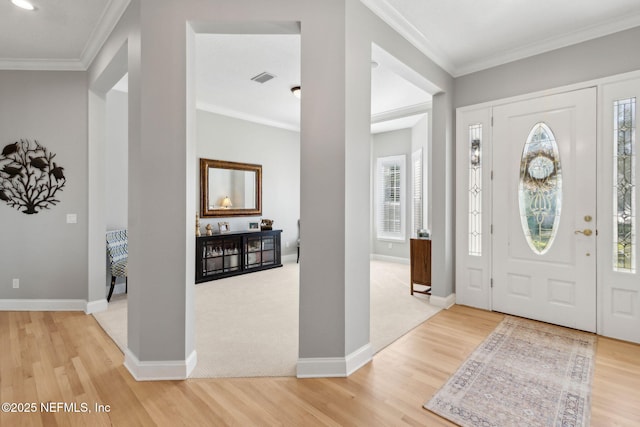 5698 Grand Cayman Rd, Jacksonville, FL 32226 - entryway with light wood-type flooring, visible vents, baseboards, and crown molding
