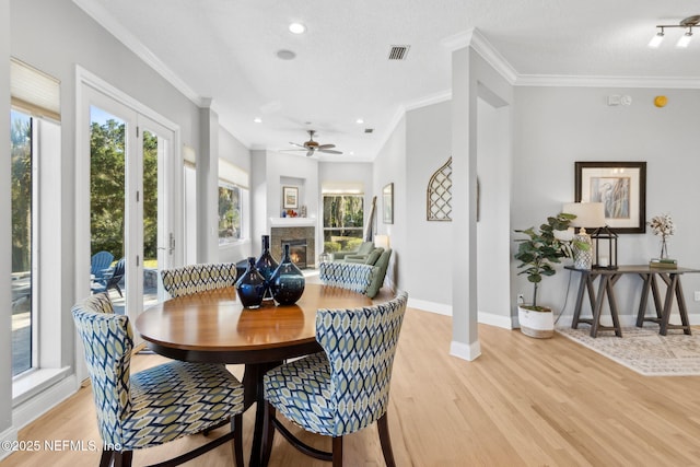 5698 Grand Cayman Rd, Jacksonville, FL 32226 - dining room featuring visible vents, baseboards, light wood-style floors, and ornamental molding