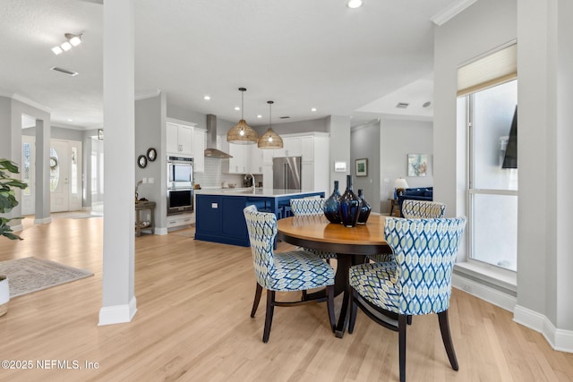 5698 Grand Cayman Rd, Jacksonville, FL 32226 - dining space with crown molding, recessed lighting, light wood-style floors, and baseboards