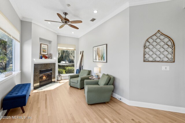 5698 Grand Cayman Rd, Jacksonville, FL 32226 - living area featuring ceiling fan, baseboards, ornamental molding, a fireplace, and wood finished floors