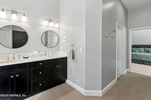 5698 Grand Cayman Rd, Jacksonville, FL 32226 - bathroom with double vanity, connected bathroom, baseboards, and a sink