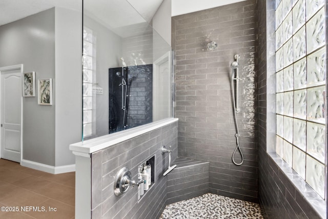 5698 Grand Cayman Rd, Jacksonville, FL 32226 - bathroom featuring tile patterned floors, baseboards, and a walk in shower