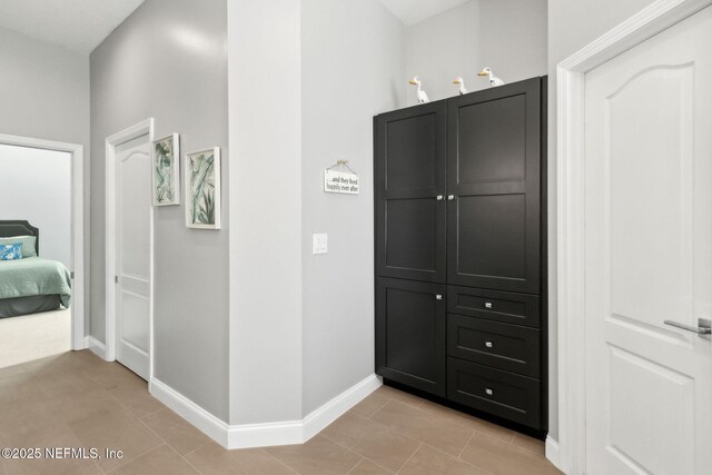 5698 Grand Cayman Rd, Jacksonville, FL 32226 - corridor with light tile patterned flooring and baseboards