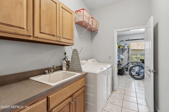 5698 Grand Cayman Rd, Jacksonville, FL 32226 - laundry area with washer and dryer, light tile patterned floors, cabinet space, and a sink
