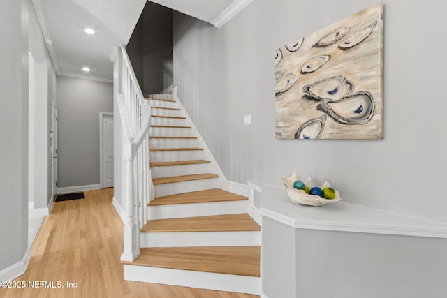 5698 Grand Cayman Rd, Jacksonville, FL 32226 - staircase featuring recessed lighting, wood finished floors, baseboards, and ornamental molding