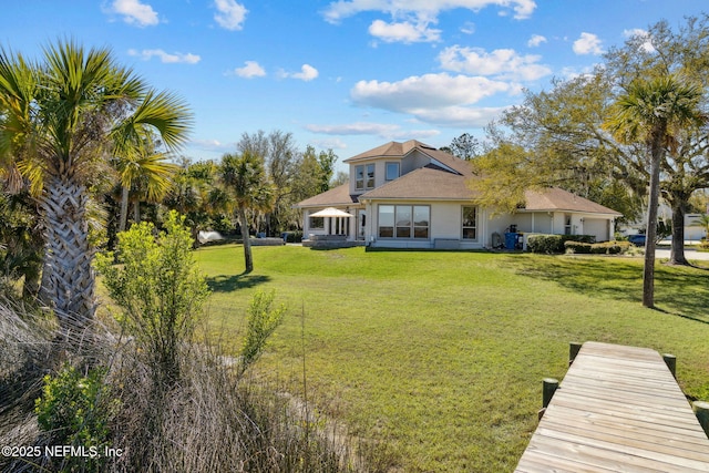 5698 Grand Cayman Rd, Jacksonville, FL 32226 - back of property featuring a lawn and an attached garage