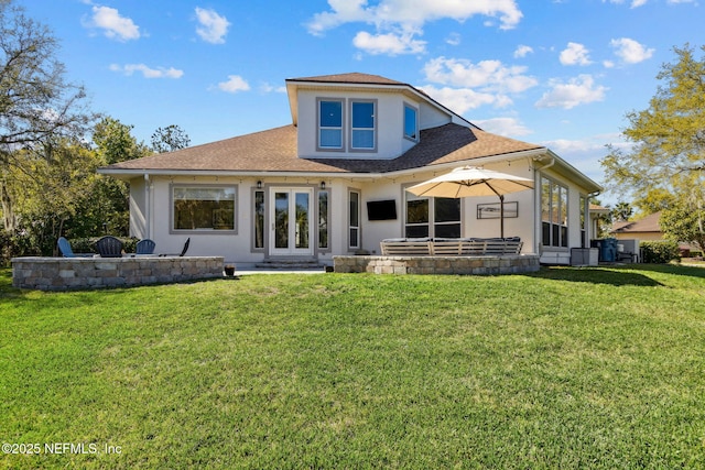 5698 Grand Cayman Rd, Jacksonville, FL 32226 - back of property featuring stucco siding, a lawn, french doors, a shingled roof, and a patio area