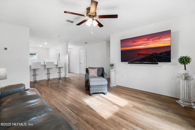 19 Slipper Flower Path E, Palm Coast, FL 32164 - living area featuring baseboards, visible vents, wood finished floors, and ceiling fan