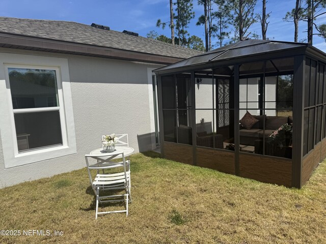 19 Slipper Flower Path E, Palm Coast, FL 32164 - rear view of house with a sunroom, stucco siding, a yard, and a shingled roof