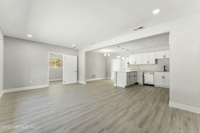 unfurnished living room with recessed lighting, baseboards, visible vents, and light wood finished floors