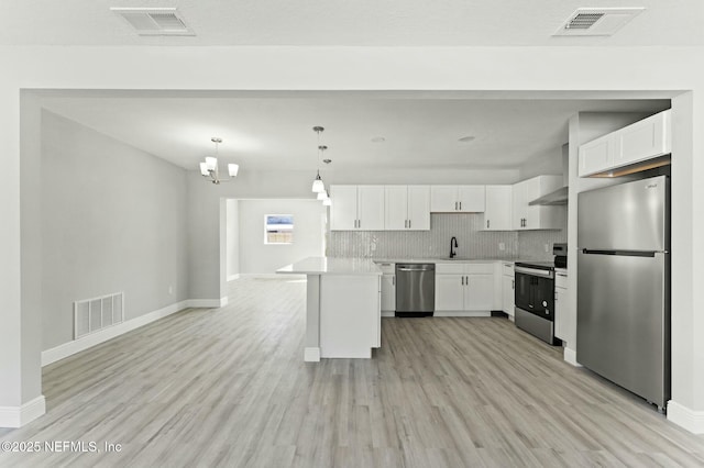 kitchen featuring visible vents, backsplash, and appliances with stainless steel finishes