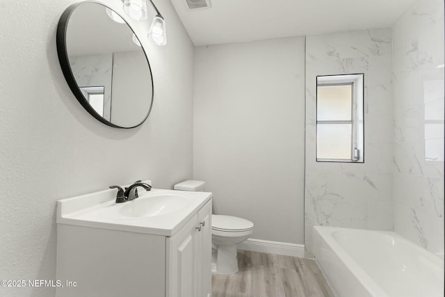 bathroom with visible vents, toilet, wood finished floors, baseboards, and vanity