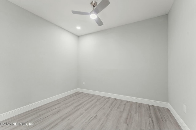 unfurnished room with baseboards, light wood-style floors, and a ceiling fan