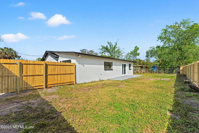 view of yard with a patio area and a fenced backyard
