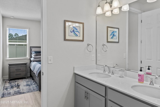 7091 Red Timber Rd, Jacksonville, FL 32244 - ensuite bathroom featuring a textured ceiling, double vanity, ensuite bathroom, and a sink