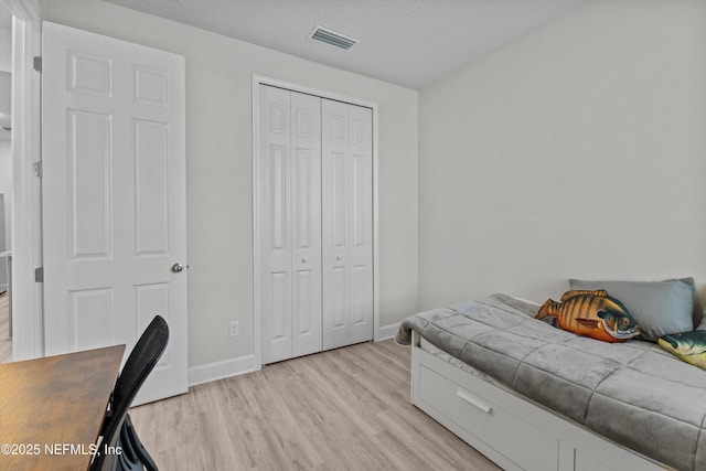 7091 Red Timber Rd, Jacksonville, FL 32244 - bedroom with light wood finished floors, visible vents, a closet, and baseboards