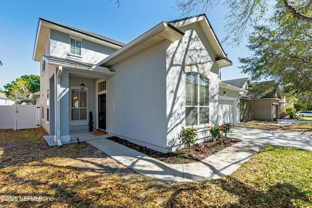 3852 Westridge Dr, Orange Park, FL 32065 - view of front of house featuring fence, stucco siding, a garage, driveway, and a gate