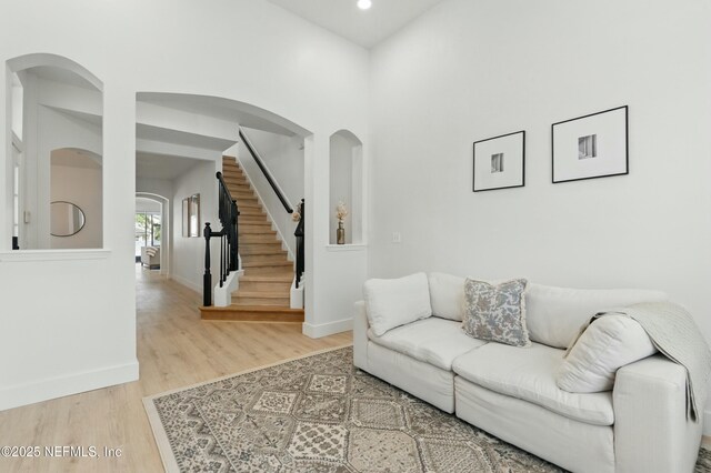 3852 Westridge Dr, Orange Park, FL 32065 - living room with baseboards, stairs, recessed lighting, wood finished floors, and arched walkways