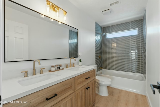 3852 Westridge Dr, Orange Park, FL 32065 - full bathroom with visible vents, toilet, wood finished floors, and a sink