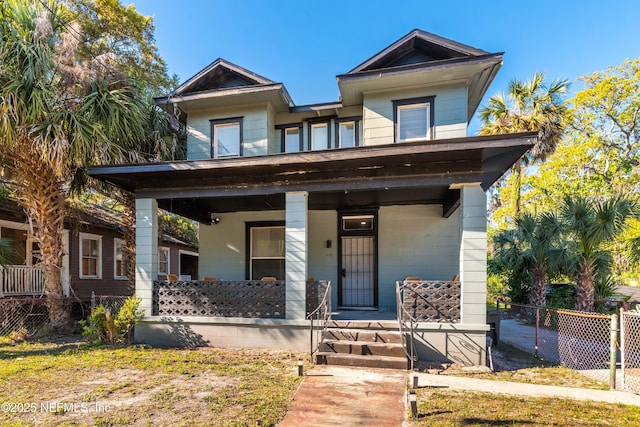 view of front of house featuring fence and a porch