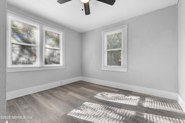 unfurnished room with baseboards, wood finished floors, and ceiling fan