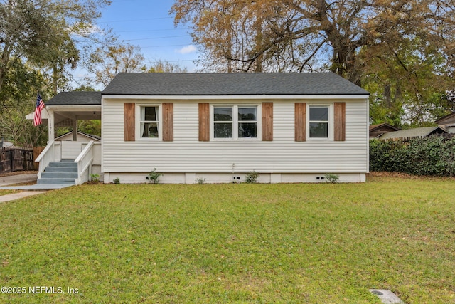 1171 Scotten Rd, Jacksonville, FL 32205 - view of front facade with crawl space, a front yard, a carport, and roof with shingles