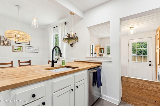 1171 Scotten Rd, Jacksonville, FL 32205 - kitchen featuring butcher block countertops, a wealth of natural light, a sink, and dishwasher