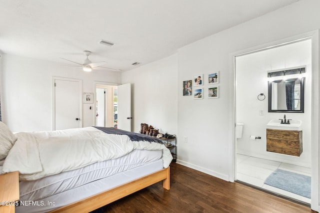1171 Scotten Rd, Jacksonville, FL 32205 - bedroom featuring baseboards, a sink, connected bathroom, visible vents, and wood finished floors