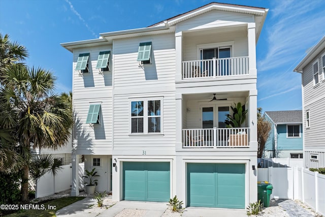 31 26th Ave S, Jacksonville Beach, FL 32250 - coastal inspired home featuring concrete driveway, an attached garage, fence, and a balcony