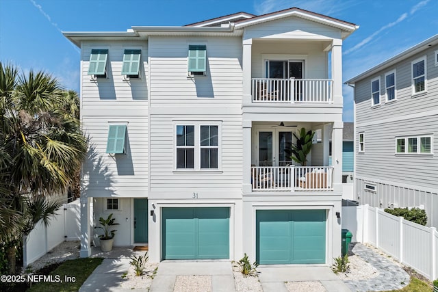 31 26th Ave S, Jacksonville Beach, FL 32250 - coastal inspired home featuring fence, an attached garage, driveway, and a balcony