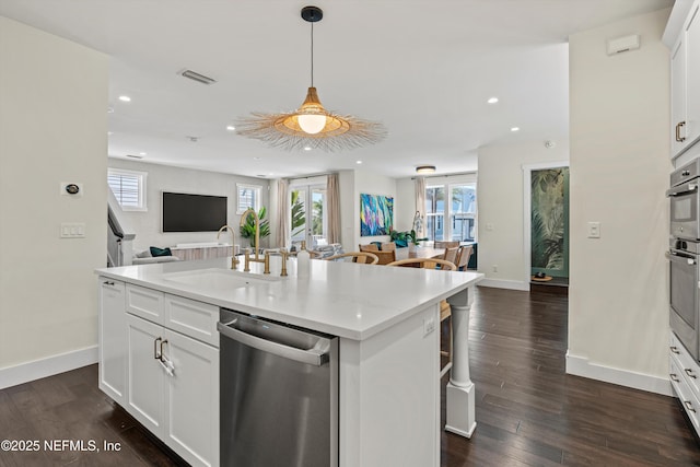 31 26th Ave S, Jacksonville Beach, FL 32250 - kitchen featuring stainless steel dishwasher, visible vents, baseboards, open floor plan, and a sink