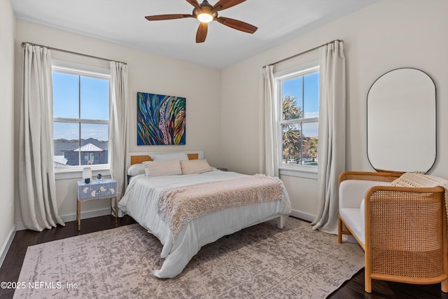 31 26th Ave S, Jacksonville Beach, FL 32250 - bedroom with baseboards, dark wood-style flooring, and multiple windows