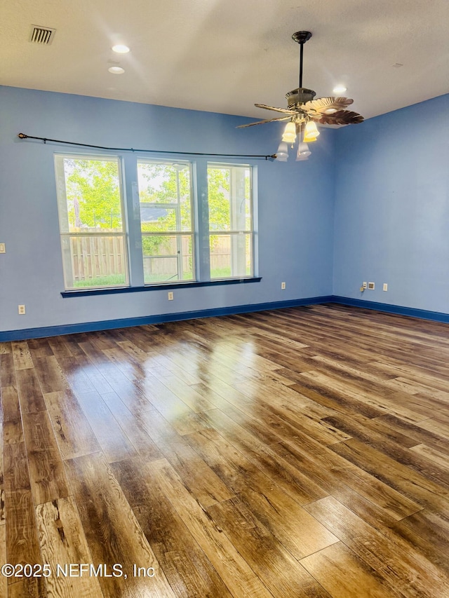 11770 Huckleberry Trl E, Macclenny, FL 32063 - empty room with wood-type flooring, healthy amount of natural light, baseboards, a ceiling fan, and recessed lighting