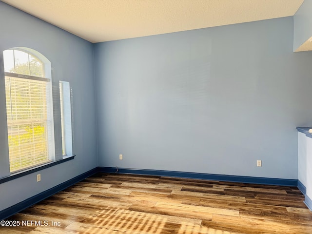 11770 Huckleberry Trl E, Macclenny, FL 32063 - unfurnished room featuring wood finished floors and baseboards