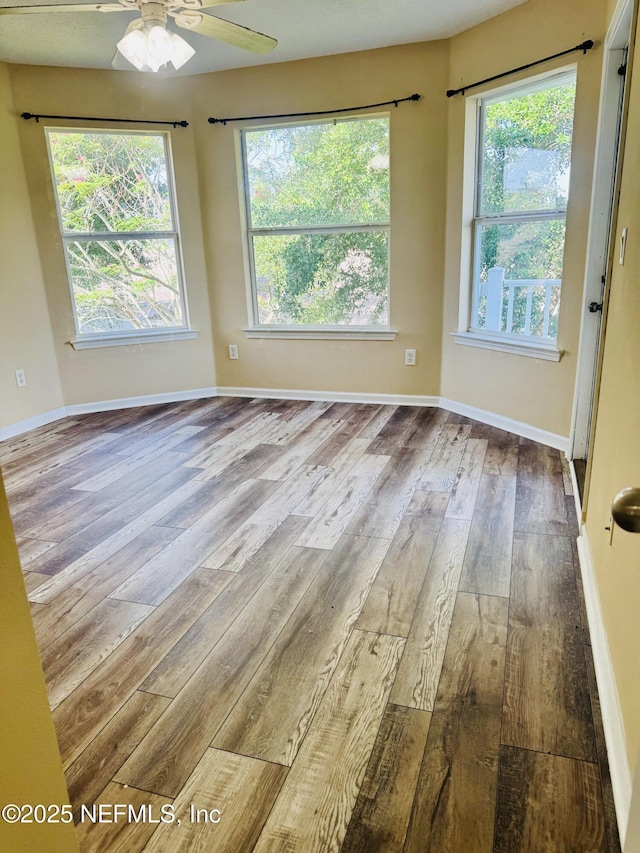 11770 Huckleberry Trl E, Macclenny, FL 32063 - unfurnished room with wood-type flooring, ceiling fan, and baseboards
