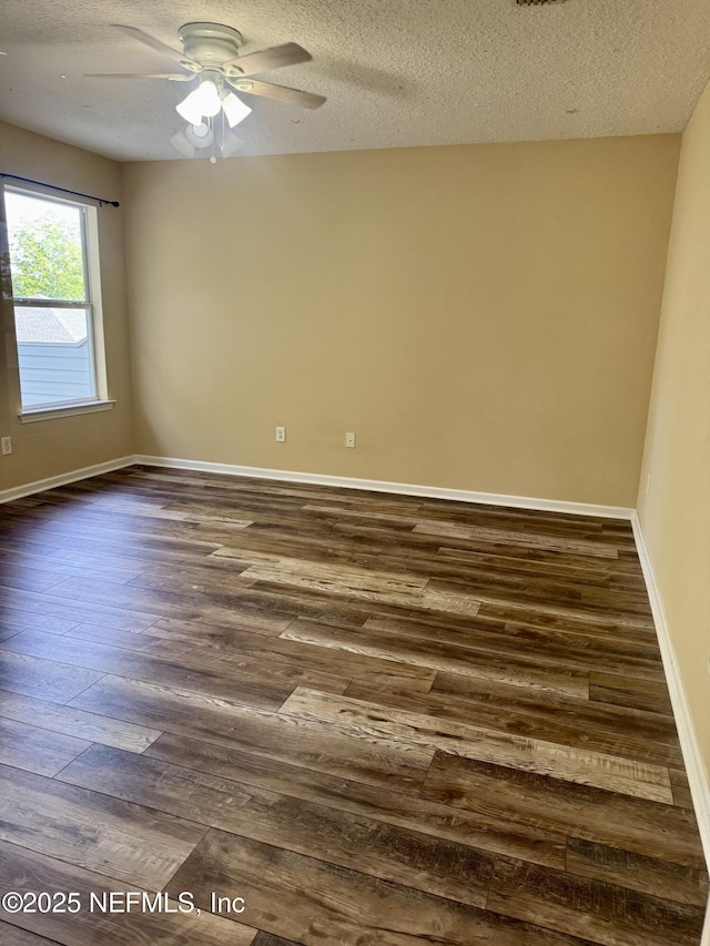 11770 Huckleberry Trl E, Macclenny, FL 32063 - empty room with dark wood finished floors, a textured ceiling, a ceiling fan, and baseboards
