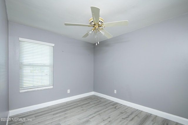 empty room featuring baseboards, a ceiling fan, and wood finished floors