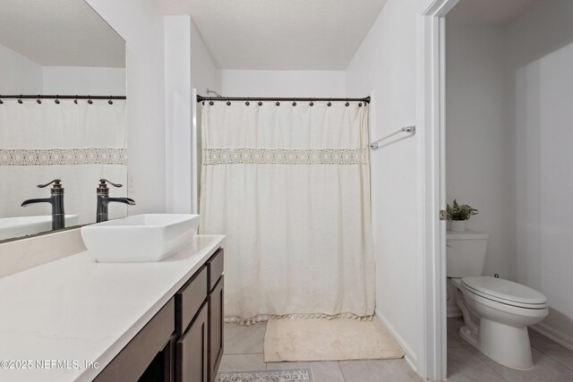 79 Coastline Way, Saint Augustine, FL 32092 - full bathroom with toilet, curtained shower, vanity, tile patterned flooring, and baseboards
