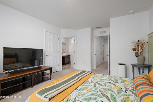 79 Coastline Way, Saint Augustine, FL 32092 - bedroom featuring connected bathroom, visible vents, and light carpet